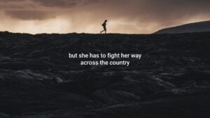 A solitary figure walks across a rugged, rocky terrain under a dramatic, cloudy sky, captured beautifully by Biteable video maker.