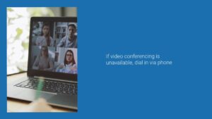 A laptop screen displaying a Biteable video conference with four participants, placed on a desk, with text advising to dial in via phone if video conferencing is unavailable.
