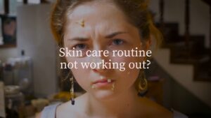 Young woman with a frustrated expression and blotches on her face, standing in a kitchen with a text overlay saying "skin care routine not working out?" created using Biteable video maker.