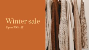 A row of winter clothing items, including sweaters and jackets, on hangers with text on the left generated by Biteable video maker stating "winter sale up to 70% off." The background