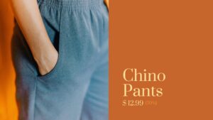 A close-up of gray chino pants with a hands-in-pocket pose, on a vibrant orange background, displayed in a Biteable video maker, showing a sale price of $12.99 (70