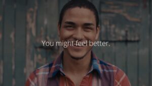 Young man smiling in a Biteable video maker with a motivational quote "you might feel better.
