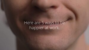 Close-up of a person's lower face with Biteable video maker text overlay: "Here are 5 ways to be happier at work.