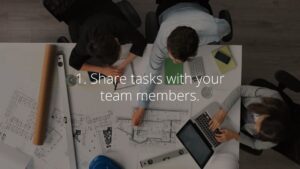 Overhead view of a collaborative team working on architectural plans and using Biteable video maker on a laptop.