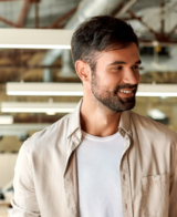 A diverse group of professionals engaging in a discussion while walking through a modern office space.