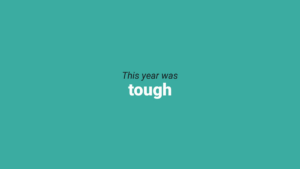A teal background with the phrase "This year was tough" in black and white text centered on the image.